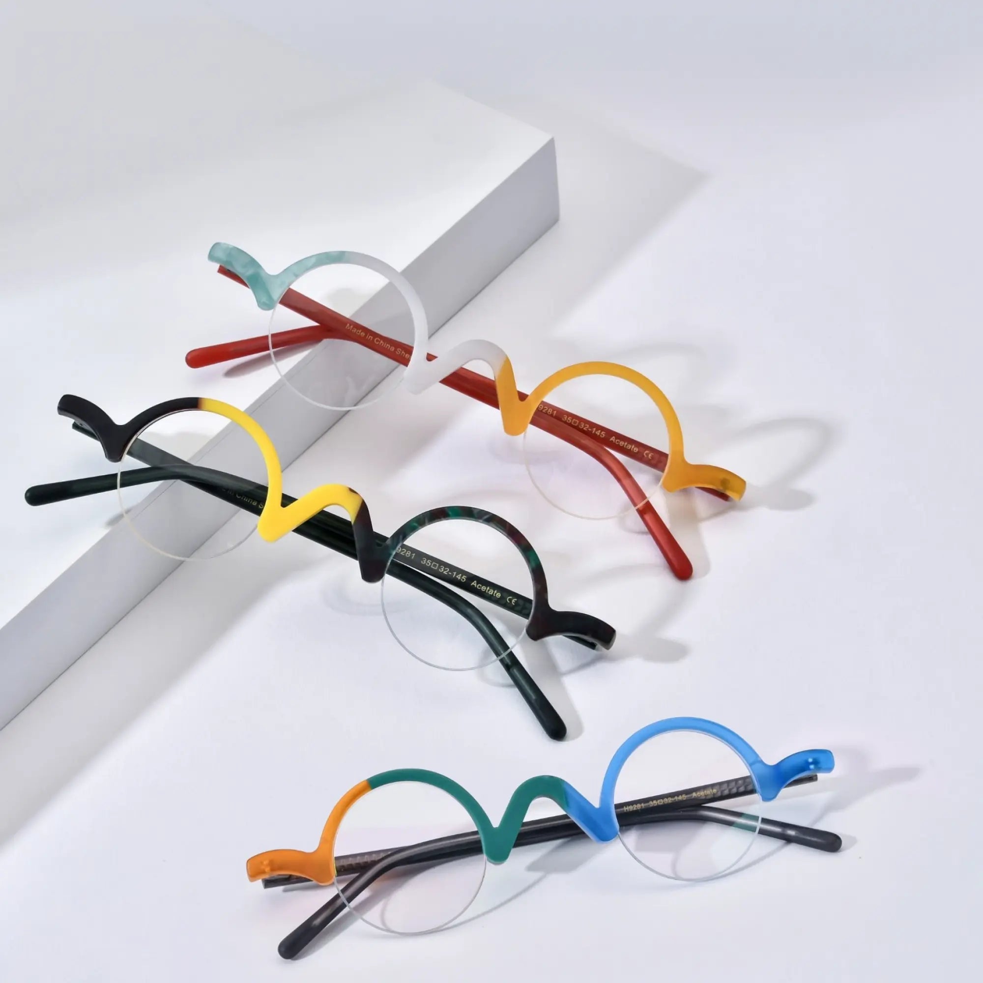 Group arrangement of VoyueLens™ semi-rimless browline eyeglasses showcasing Ivory-Orange, Lemon-Lime, Teal-Blue, and other color variants on a white background, emphasizing dual-tone matte finishes and wavy browline style.